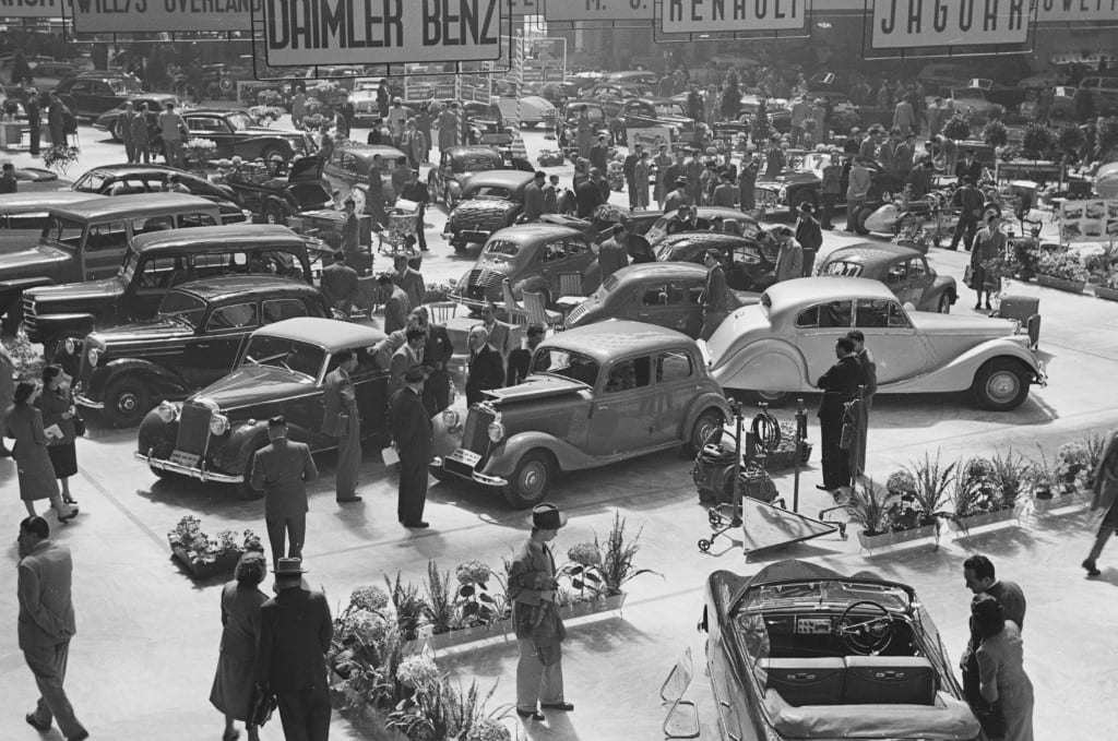 All things automotive caught the eye of Rudy Mailander, who shows, from a tree top perspective, the hustle and bustle of the Turin Motor Show display floor in 1950. 