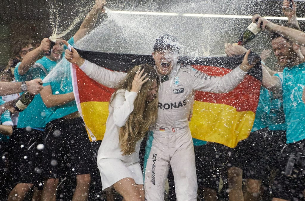 Rosberg and his wife, Vivian, get a champagne shower.
